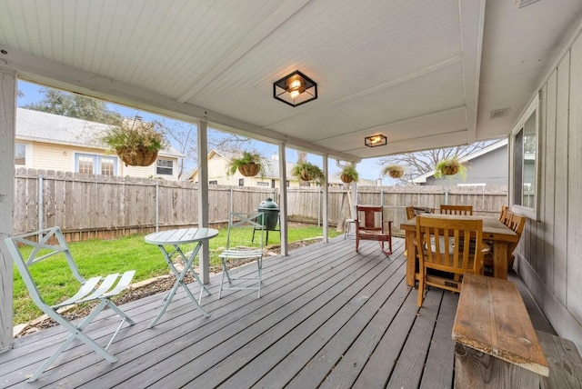 wooden terrace featuring a yard, a grill, and a fenced backyard