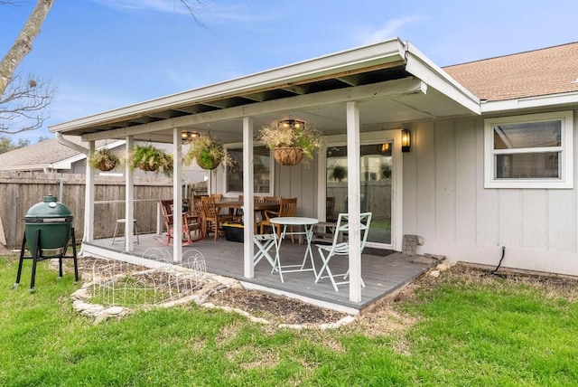 view of patio / terrace featuring a wooden deck, outdoor dining area, and fence