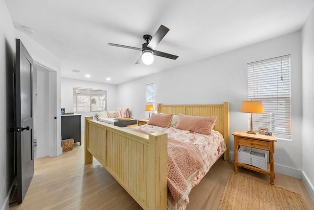 bedroom featuring light wood finished floors, recessed lighting, a ceiling fan, and baseboards