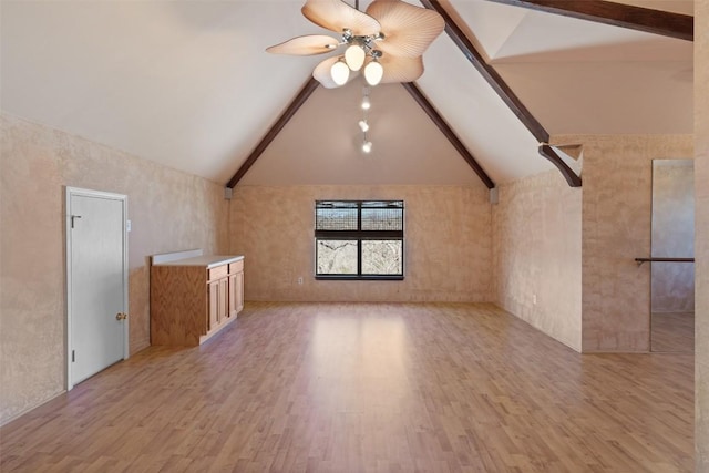 additional living space featuring light wood finished floors, beamed ceiling, high vaulted ceiling, and ceiling fan