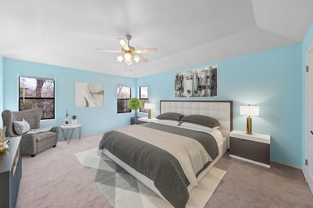 carpeted bedroom featuring baseboards and ceiling fan