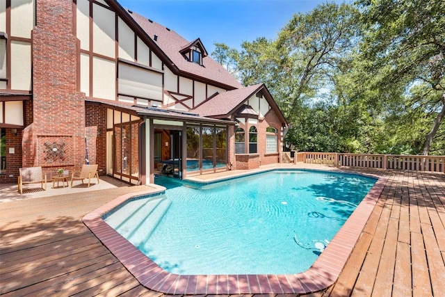 view of swimming pool with a deck and a fenced in pool