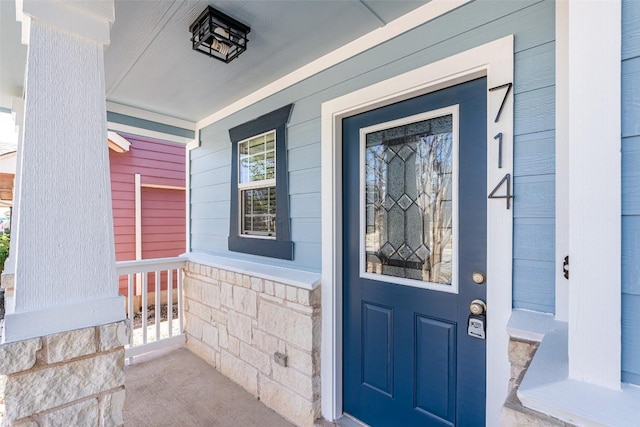 doorway to property featuring covered porch