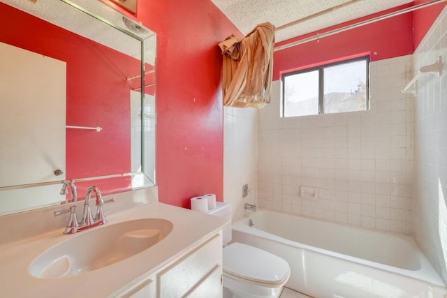 full bath with vanity, toilet, washtub / shower combination, and a textured ceiling