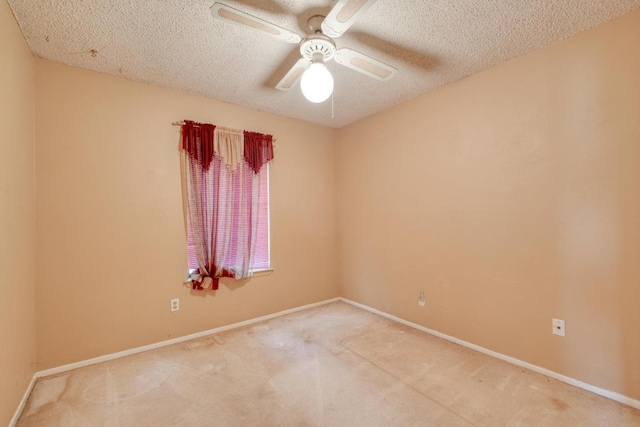 spare room with carpet flooring, a ceiling fan, baseboards, and a textured ceiling