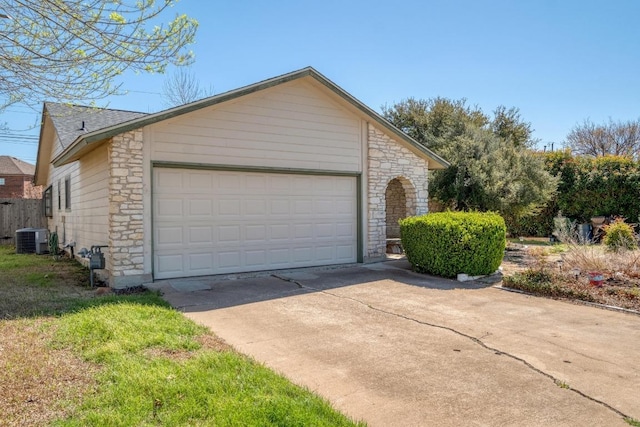 garage featuring central AC and driveway