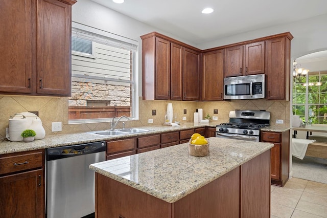 kitchen with a sink, arched walkways, backsplash, and appliances with stainless steel finishes