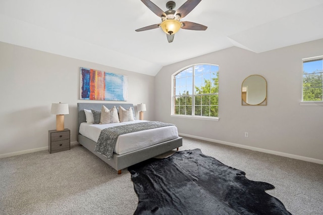 bedroom featuring lofted ceiling, carpet, baseboards, and ceiling fan