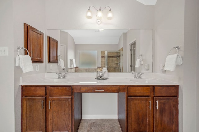 bathroom with double vanity, a shower stall, and a sink