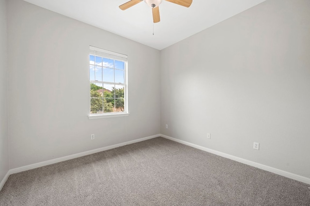 spare room with baseboards, carpet floors, and ceiling fan