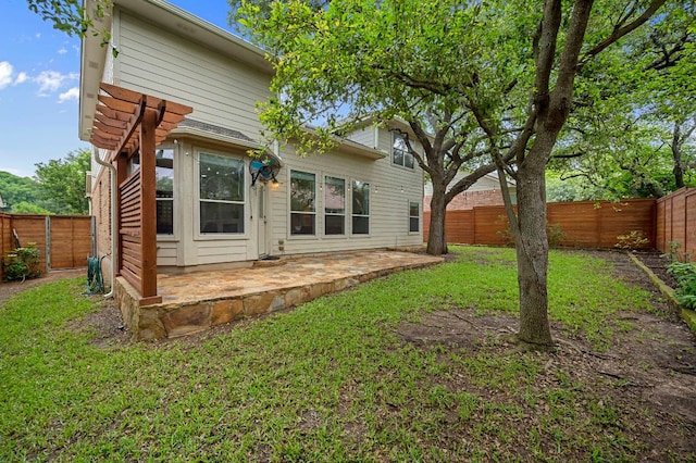 back of property with a patio, a lawn, and a fenced backyard