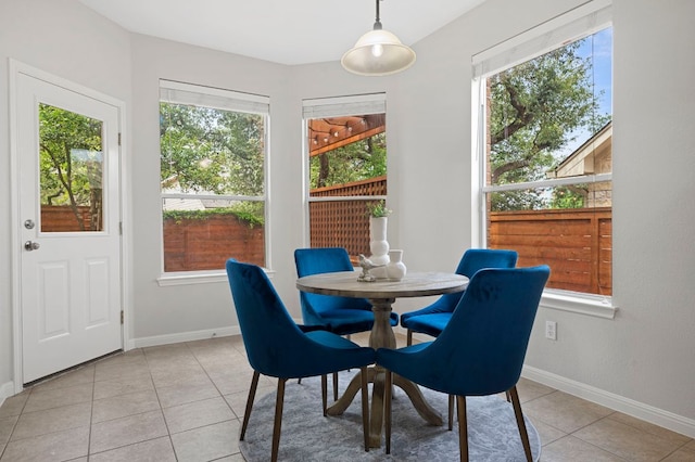 dining area with light tile patterned floors and baseboards