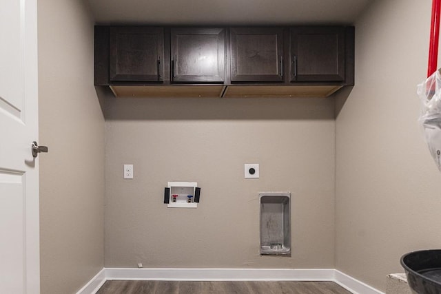 laundry area featuring cabinet space, dark wood-style floors, hookup for a washing machine, and baseboards