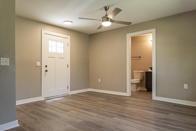 foyer entrance featuring ceiling fan, baseboards, and dark wood finished floors