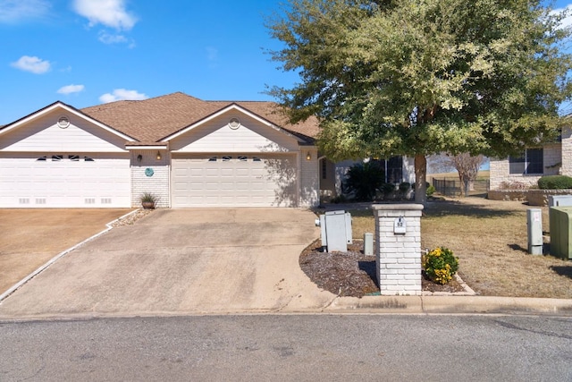 ranch-style house with brick siding, concrete driveway, and an attached garage