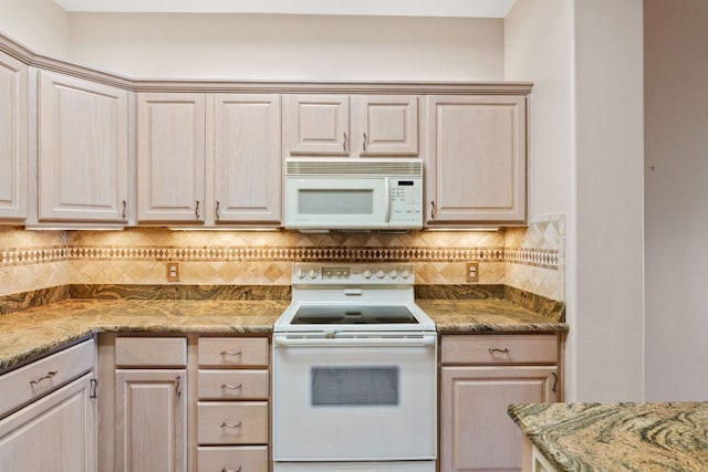 kitchen featuring backsplash, stone countertops, and white appliances