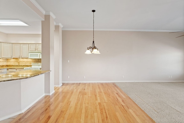 unfurnished dining area with baseboards, light wood-type flooring, and crown molding