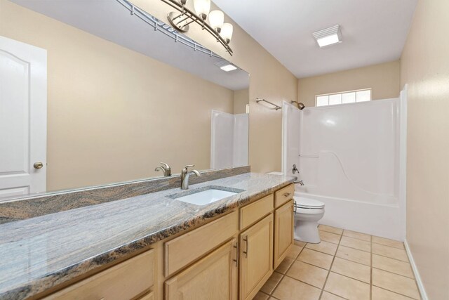 bathroom with toilet, tile patterned flooring, vanity, and washtub / shower combination