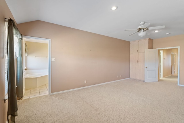 unfurnished bedroom with connected bathroom, vaulted ceiling, light carpet, baseboards, and recessed lighting