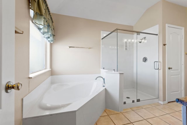 full bath with vaulted ceiling, a garden tub, tile patterned flooring, and a shower stall