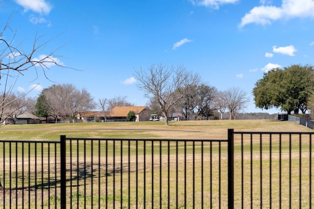 view of yard featuring fence and a rural view