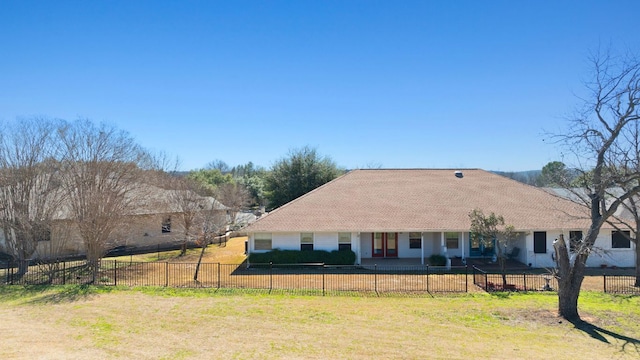 view of front of house with a fenced front yard and a front lawn