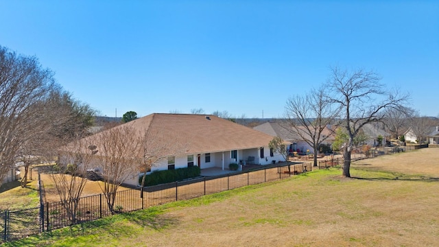 view of side of home featuring fence and a yard