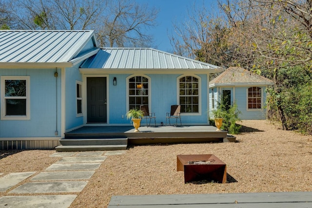 view of front of house featuring metal roof and a porch