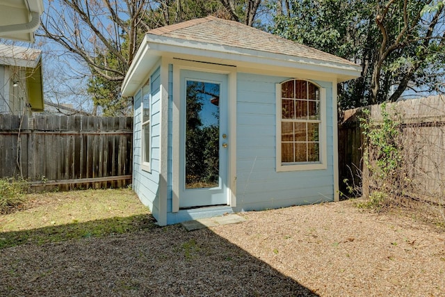 view of outbuilding with a fenced backyard and an outdoor structure