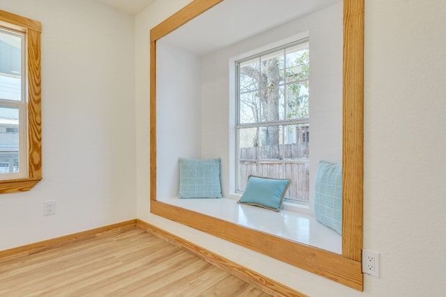 interior space with baseboards and wood finished floors