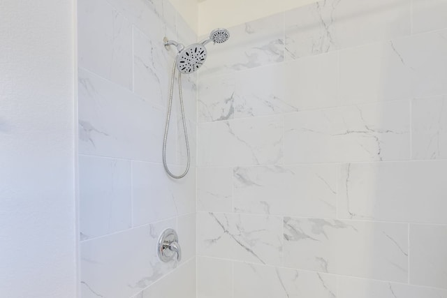 bathroom with a tile shower