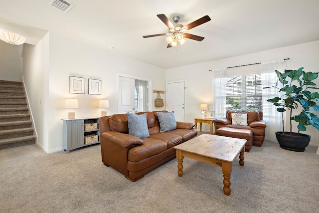 102 Tokalaun Dr, Hutto, TX 78634 - living area featuring stairs, a ceiling fan, and light colored carpet