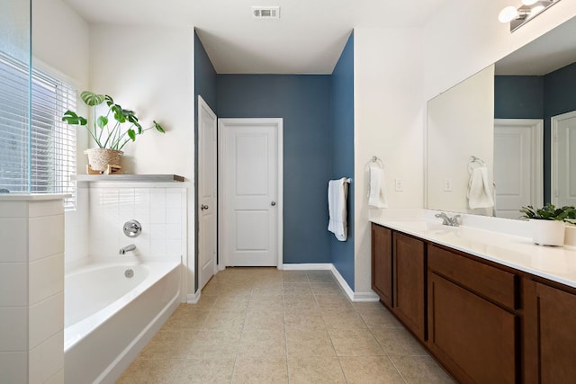 102 Tokalaun Dr, Hutto, TX 78634 - full bath featuring vanity, a garden tub, and tile patterned floors