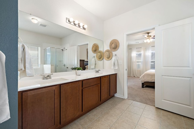 102 Tokalaun Dr, Hutto, TX 78634 - full bathroom with a shower stall, double vanity, tile patterned flooring, and ensuite bathroom