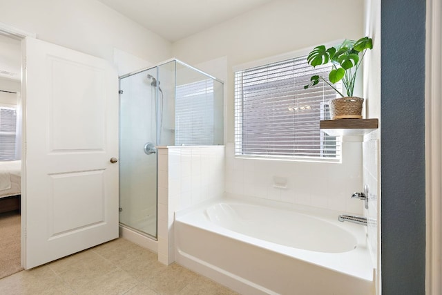 102 Tokalaun Dr, Hutto, TX 78634 - ensuite bathroom featuring a garden tub, a shower stall, and tile patterned flooring