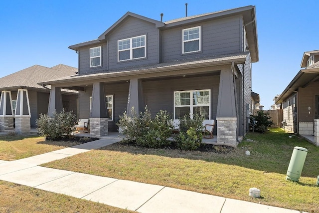102 Tokalaun Dr, Hutto, TX 78634 - view of front of home with a porch, stone siding, and a front lawn