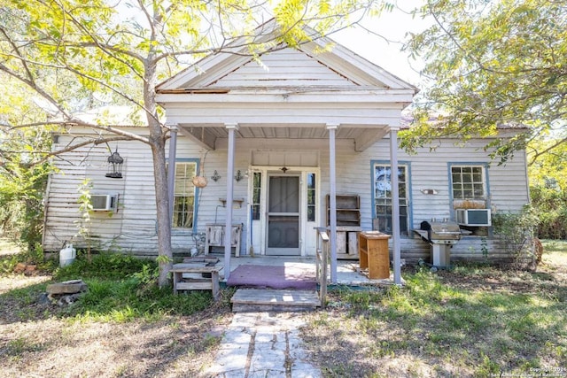 view of front of house featuring a porch and cooling unit