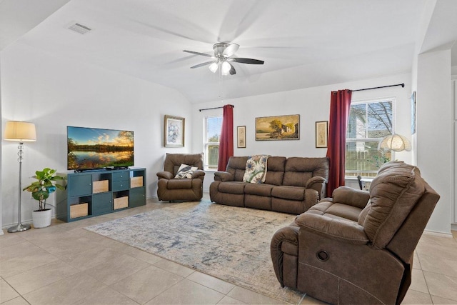 living room featuring lofted ceiling, a healthy amount of sunlight, visible vents, and ceiling fan