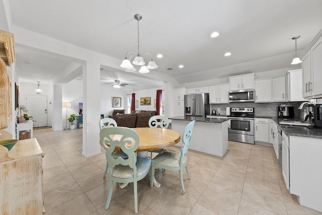 dining room with recessed lighting, light tile patterned flooring, and ceiling fan with notable chandelier