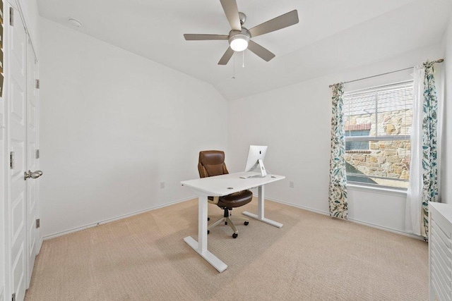 home office with light carpet, baseboards, lofted ceiling, and a ceiling fan