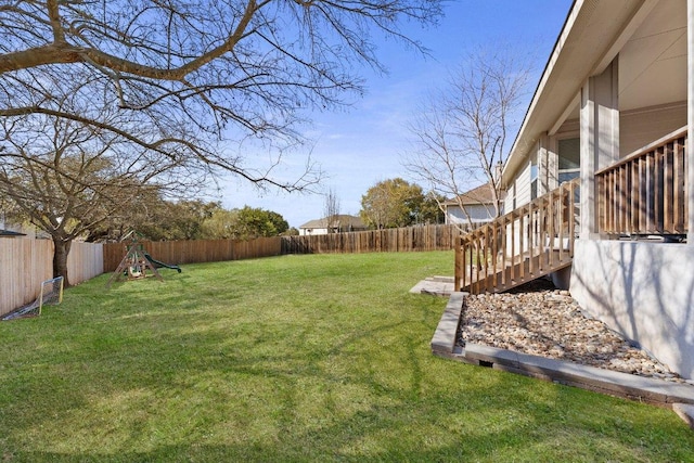 view of yard featuring a fenced backyard and a playground