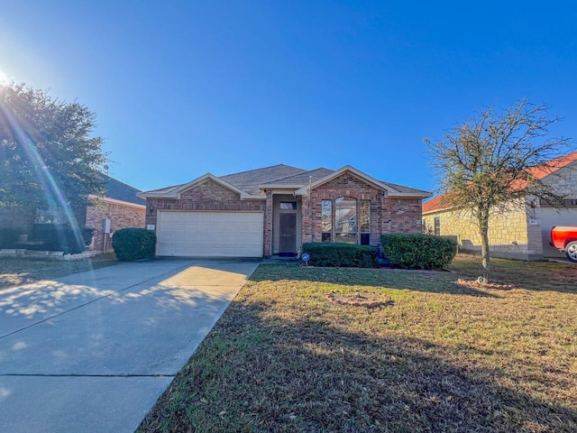 ranch-style home with a front lawn, a garage, brick siding, and driveway