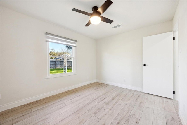 unfurnished room with visible vents, ceiling fan, baseboards, and light wood-style floors