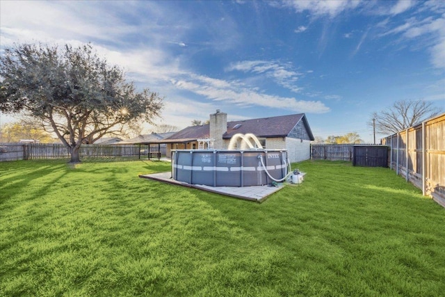 view of yard with a fenced in pool and a fenced backyard