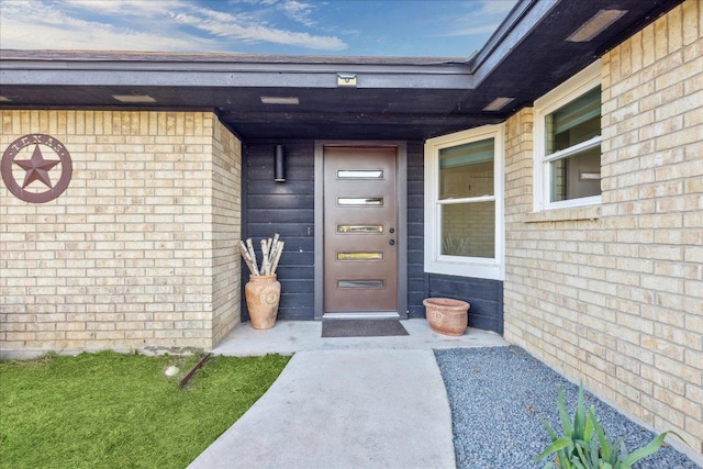 property entrance with brick siding