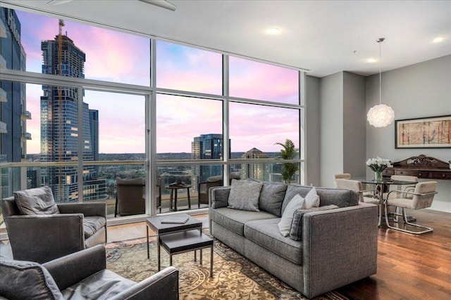 living room featuring a city view, wood finished floors, and expansive windows