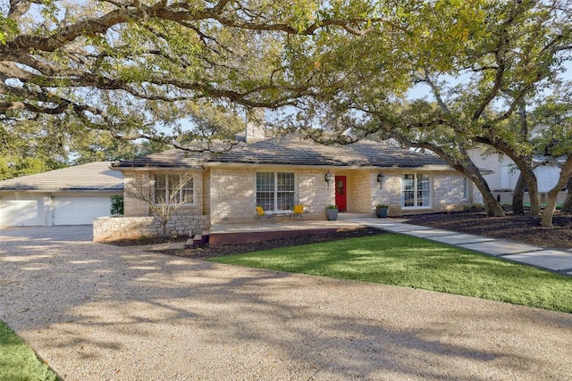 single story home with a garage and stone siding