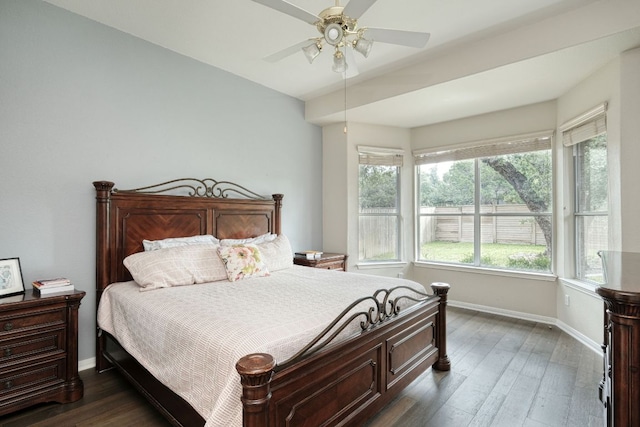 bedroom featuring a ceiling fan, baseboards, and dark wood-style flooring