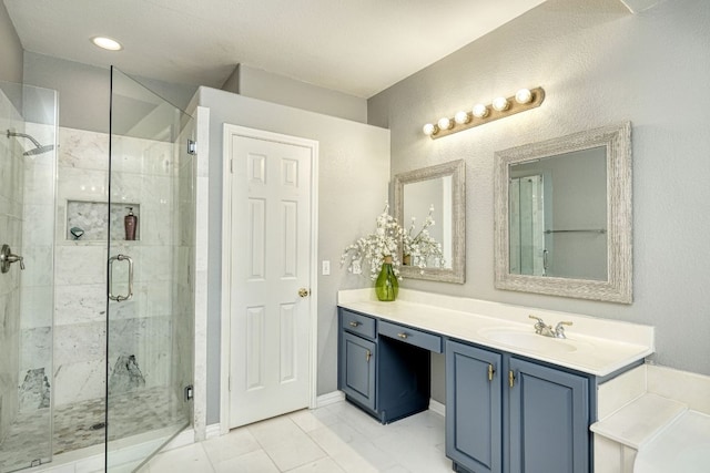 full bathroom featuring marble finish floor, recessed lighting, a shower stall, baseboards, and vanity