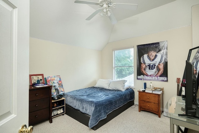 carpeted bedroom with baseboards, a ceiling fan, and vaulted ceiling